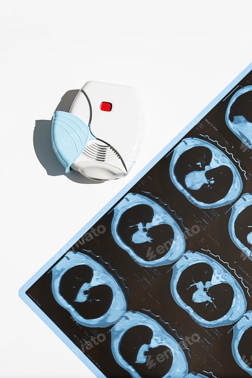 Preview: Asthma Inhaler and CT Scan of the Lungs on White Table.