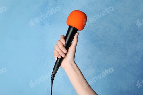 Preview: Woman holding microphone on color background, closeup