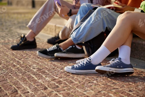 Preview: Legs of university students doing homework