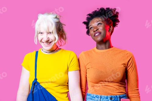 Preview: Two young diverse multicultural caucasian and black women best friends posing