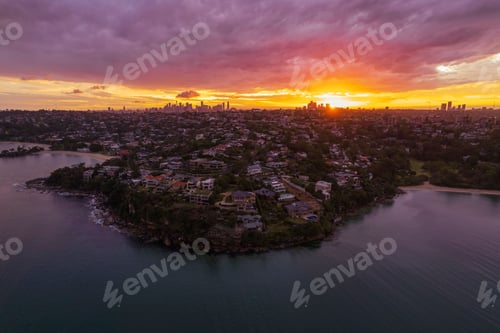 Preview: Aerial view of the stunning sunset at Sydney harbor with urban houses on the shore