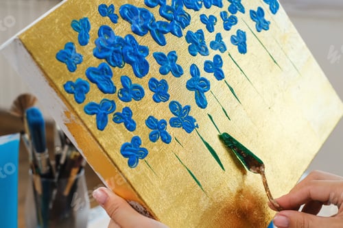 Preview: Artist painting with spatula and acrylic paints in studio, hand closeup