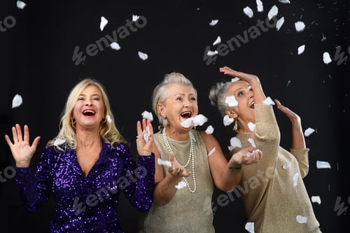 Preview: Portrait of three beautiful senior friends celebrating.