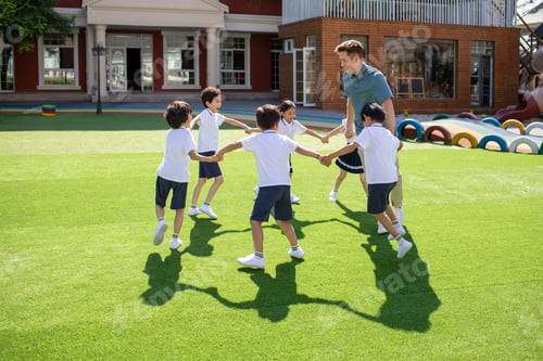 Preview: Foreign teacher and children playing in kindergarten playground
