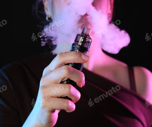 Preview: Woman using electronic smoking device in neon lights on black background, closeup
