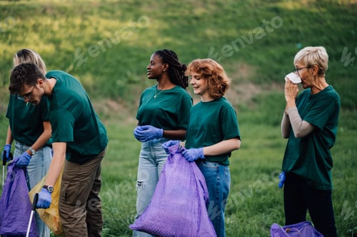 Preview: Group of people volunteers collecting rubbish in park