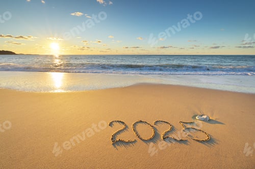 Preview: 2025 year on the sea sand beach shore during sunset.
