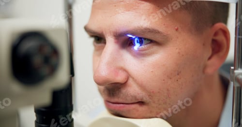 Preview: Man, optometry and slit lamp for check, vision and care in wellness assessment with eyesight at cli