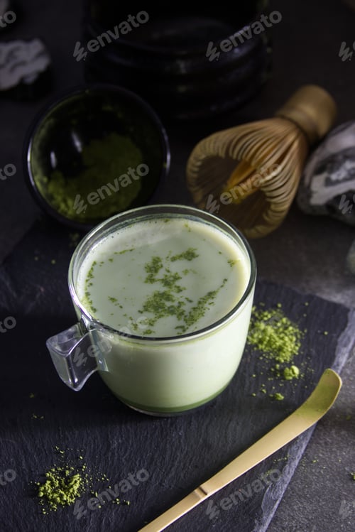 Preview: Top view of cup of matcha latte and supplies for tea ceremony
