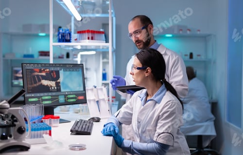 Preview: Woman scientist and man doctor studying virus expertise in medicine lab