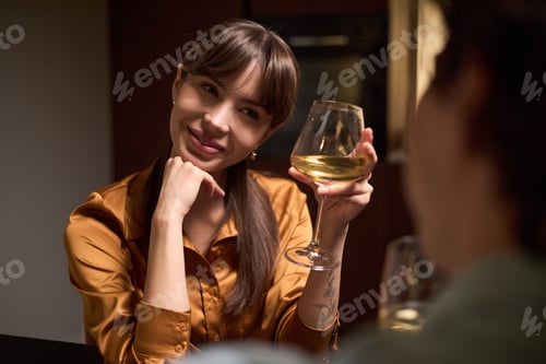 Preview: Portrait of Young Adult Woman Smiling While Holding Wine Glass