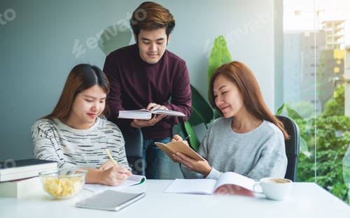 Preview: Group of young students tutoring and catching up workbook together