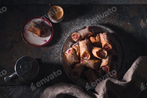 Preview: Cannoli and cup of coffee on the stone background top view