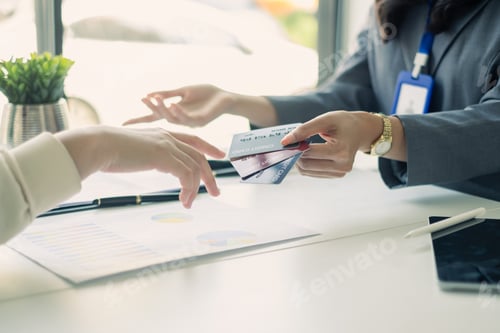 Preview: Asian business customer service representatives work serve sell credit card to customers. choosing