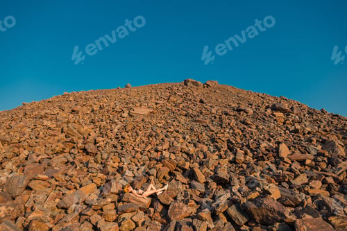 Preview: Red Ore. Mountains Of Red Ore. A Girl In A Swimsuit Lies On A Red Ore