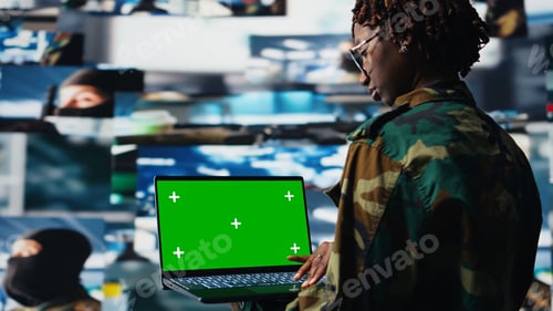 Preview: Military operator oversees mission operations using isolated screen laptop