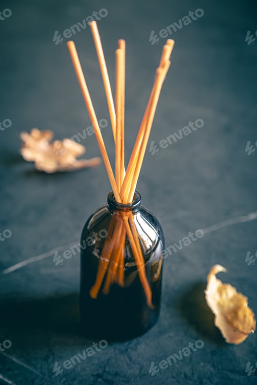 Preview: Incense sticks on a dark background and autumn leaves.