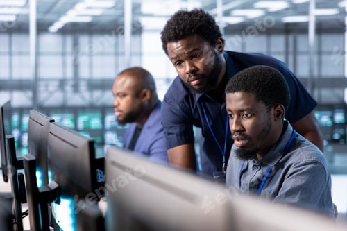 Preview: Manager in server hub overseeing workers using computer