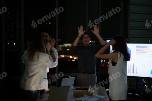 Preview: Group of broker international stock traders working actively at night in office,