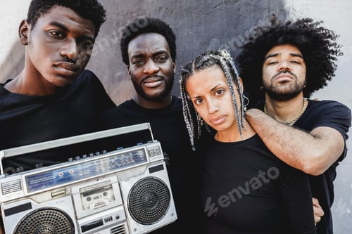 Preview: Group of young african people listening music from vintage boombox stereo outdoor