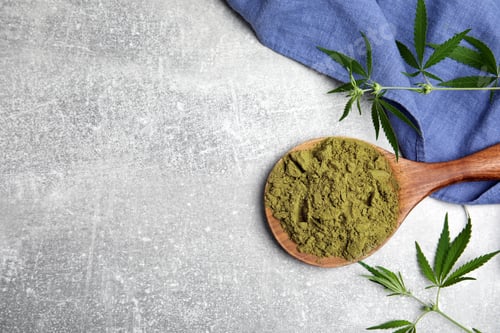Preview: Hemp protein powder and fresh leaves on light grey table, flat lay. Space for text