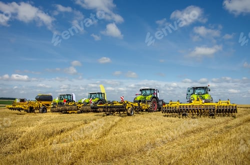 Preview: Tractors and Equipment on Agricultural Field, Clear Day
