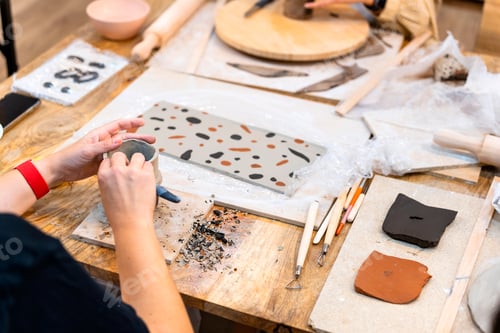 Preview: Ceramic Workshop. Young girl working with her hands ceramics