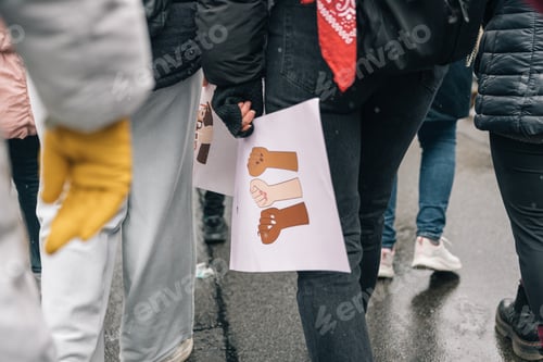 Preview: Unrecognizable women holding a banner of the symbol of feminist struggle