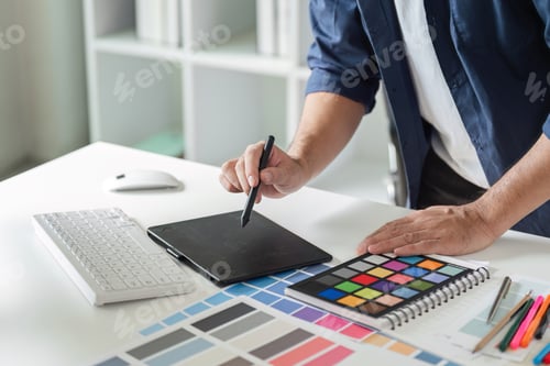 Preview: Creative Graphic Designer Planning a Project with Digital Tools and Color Swatches in a Modern