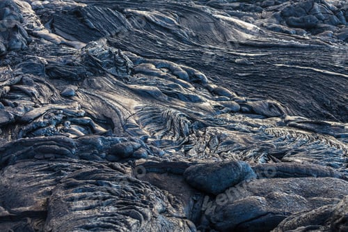 Rugged Black Lava Flows in a Volcanic Landscape