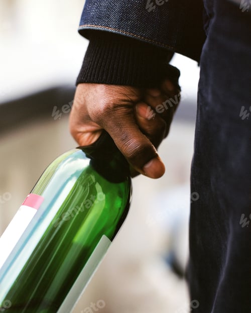 Preview: A man holding an empty bottle of wine