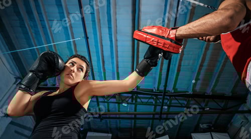 Preview: Woman Boxer Practicing Punches With a Trainer