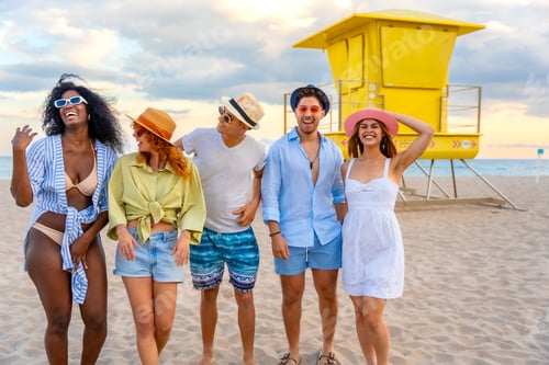 Preview: Happy friends walking on the beach at sunset near lifeguard tower