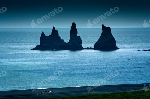 Preview: Reynisdragar natural rock formation on Atlantic ocean and group of tourist riding horses