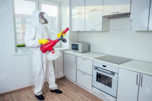 Preview: white worker spraying pesticide on induction hob