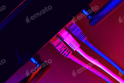Preview: Cables plugged in a Wi-Fi router on dark background