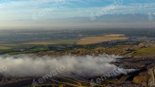 Preview: Aerial view of burning garbage piles in trash landfill