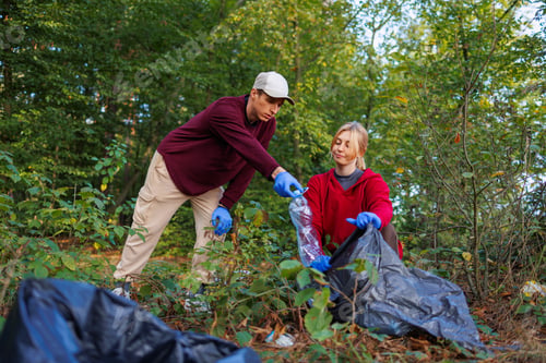 Preview: Man and woman remove plastic bottles and other waste on nature
