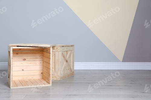 Preview: Wooden crates on floor at color wall. Space for text