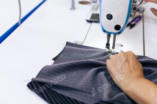 Preview: Tailor working on electric sewing machine