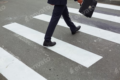 Preview: Businessman crossing road
