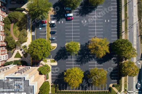 Preview: Aerial view of many colorful cars parked on parking lot on apartment building backyard.