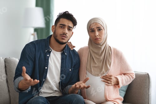 Preview: Portrait Of Worry Arab Man And Pregnant Muslim Wife Talking At Camera