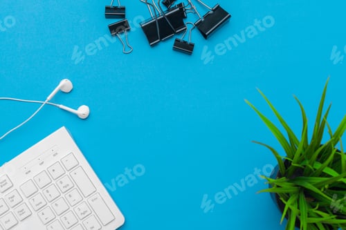 Preview: Office table desk with supplies on blue background, Top view and copy space for text