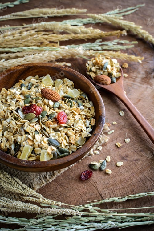 Preview: Oat and whole wheat grains flake in wooden bowl on wooden table