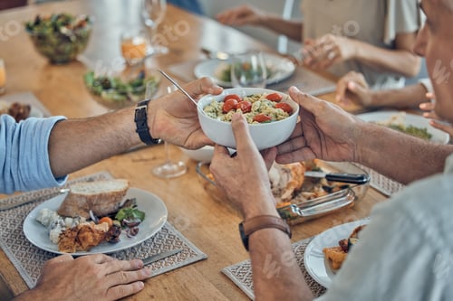 Preview: Hands, food and family with a group of people gathered around a dining room table for a meal or fea