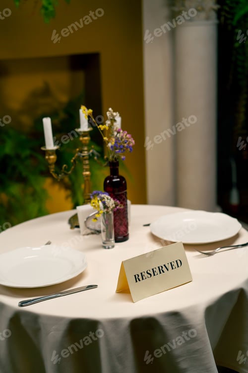 Preview: Close-up of a reservation sign reserved standing on a table in expensive luxury Italian restaurant