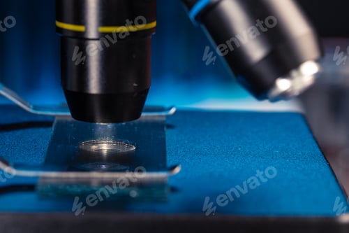 Preview: Microscope with lenses close up against dark background