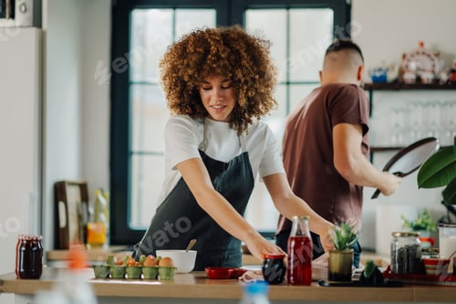Preview: Couple preparing ingredients for cooking in modern kitchen