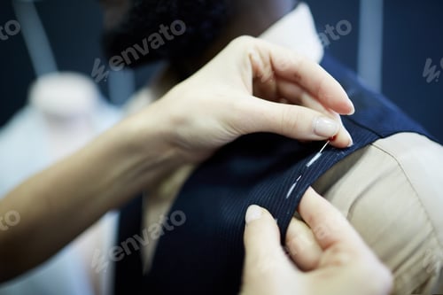 Preview: Tailor using sewing pins to fix fabric
